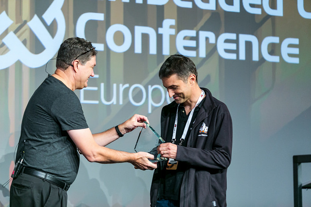 Michael Opdenacker receives an award at the Embedded Linux Conference Europe